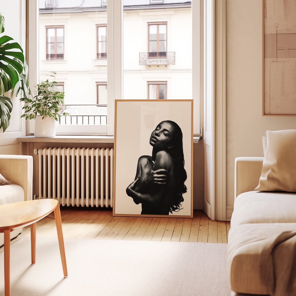 Backlit woman silhouette hugging her shoulders print in an oak frame leaning by a French window in a living room