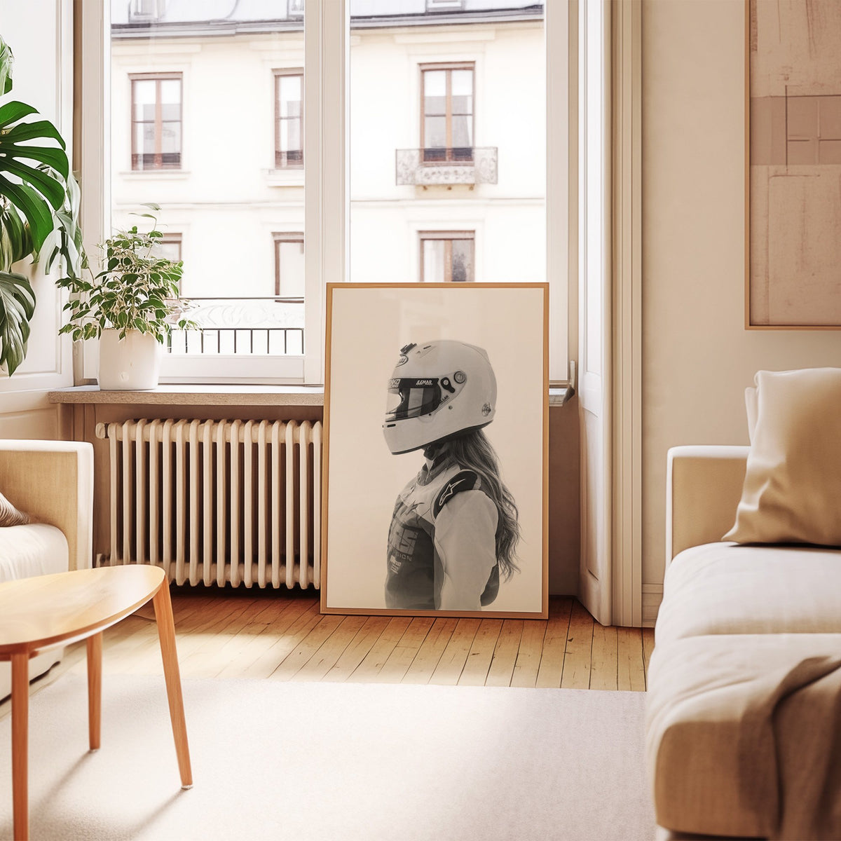 Woman in white racing helmet seen in profile print in an oak frame leaning by a French window in a living room