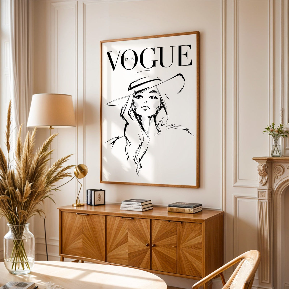 Woman in wide brim hat fashion sketch print in an oak frame above a sunburst wood sideboard with pampas grass