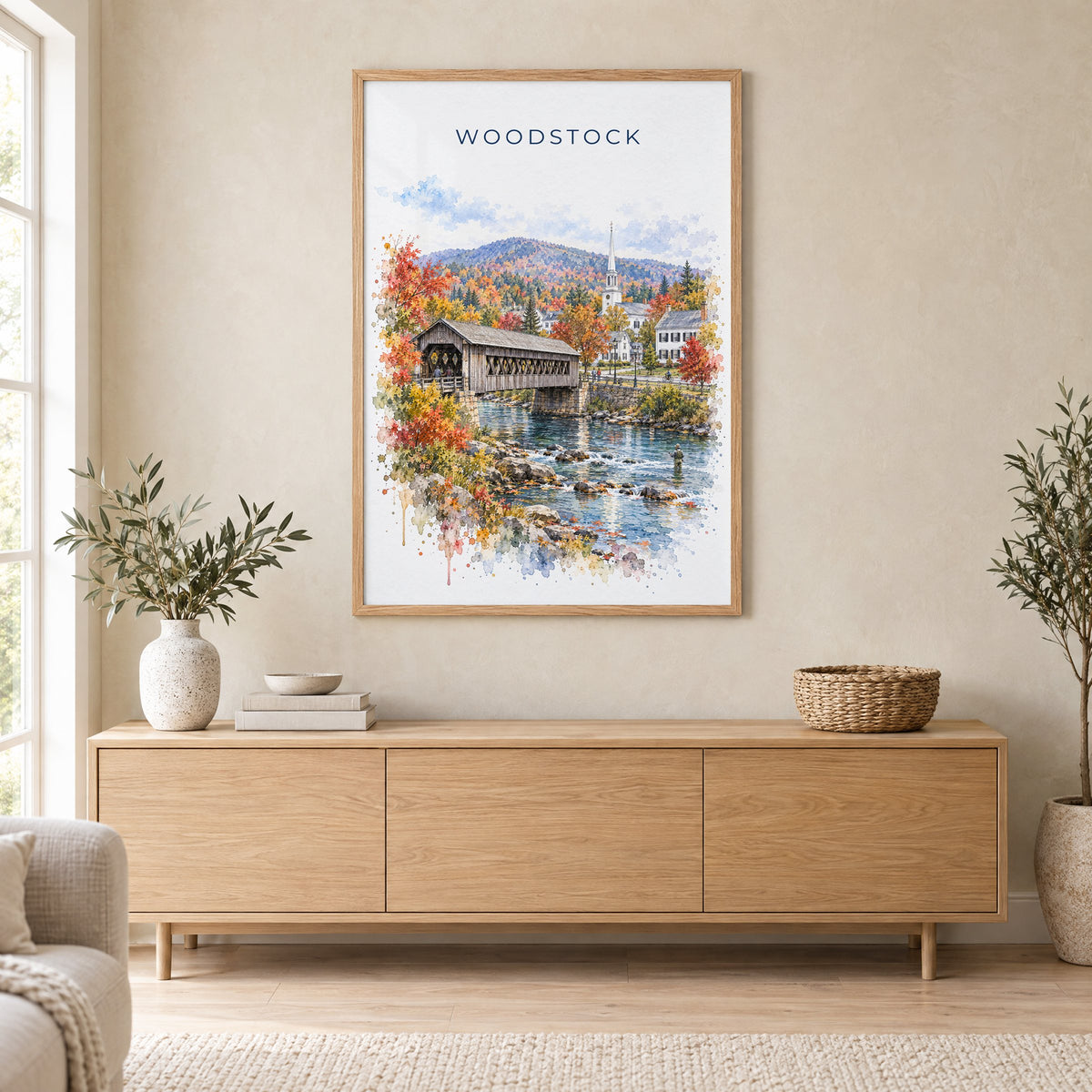 Woodstock, Vermont watercolor print in an oak frame above a light wood sideboard in a Scandinavian living room