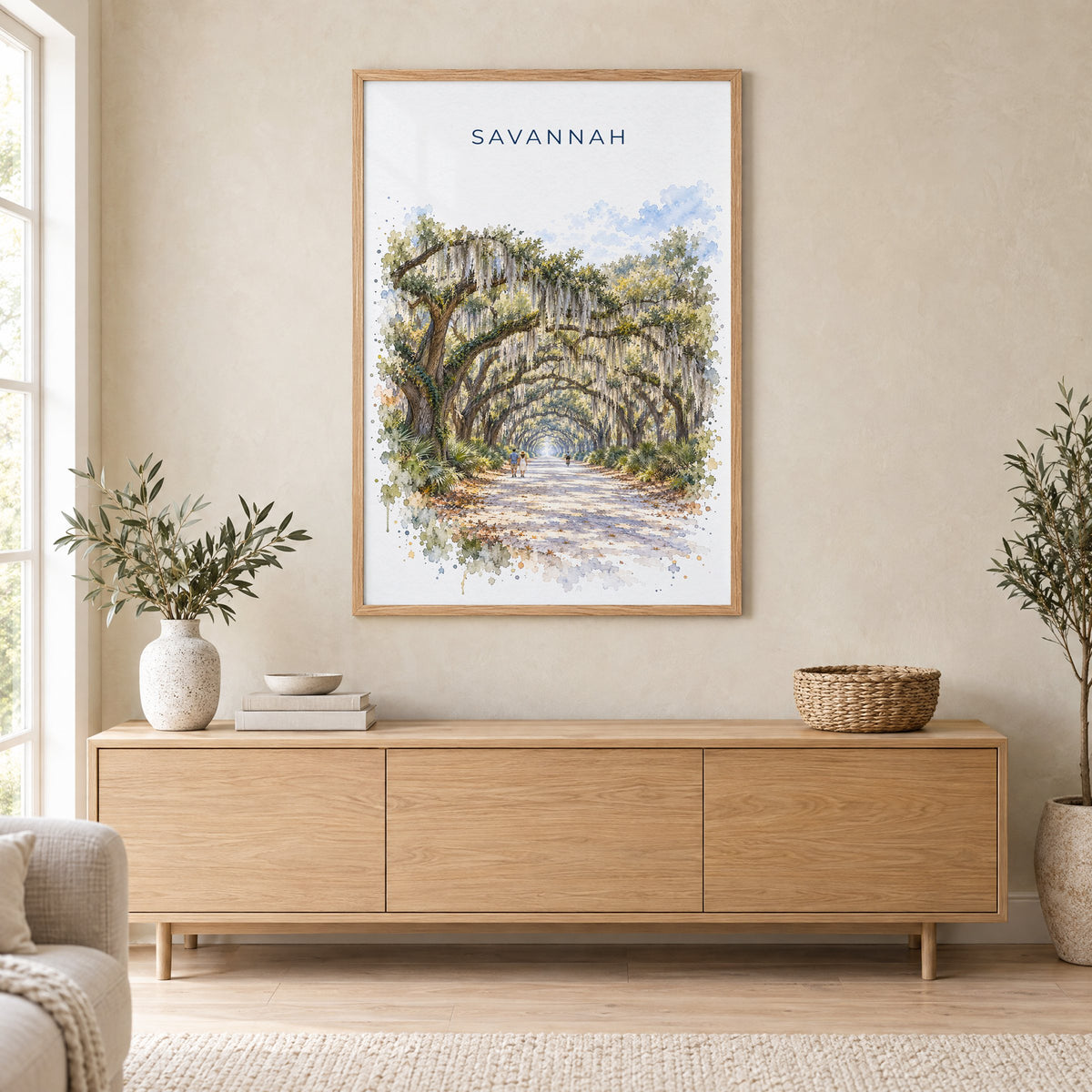 Wormsloe Savannah watercolor print in an oak frame above a light wood sideboard in a Scandinavian living room