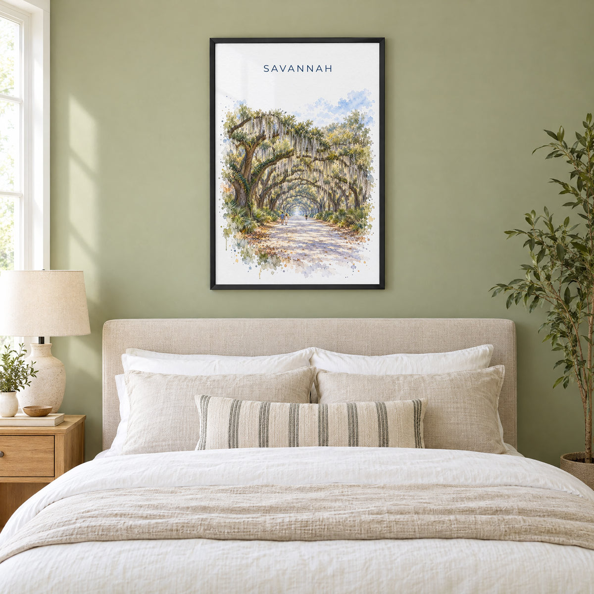 Wormsloe Savannah watercolor print in a black frame above an upholstered headboard in a sage green bedroom