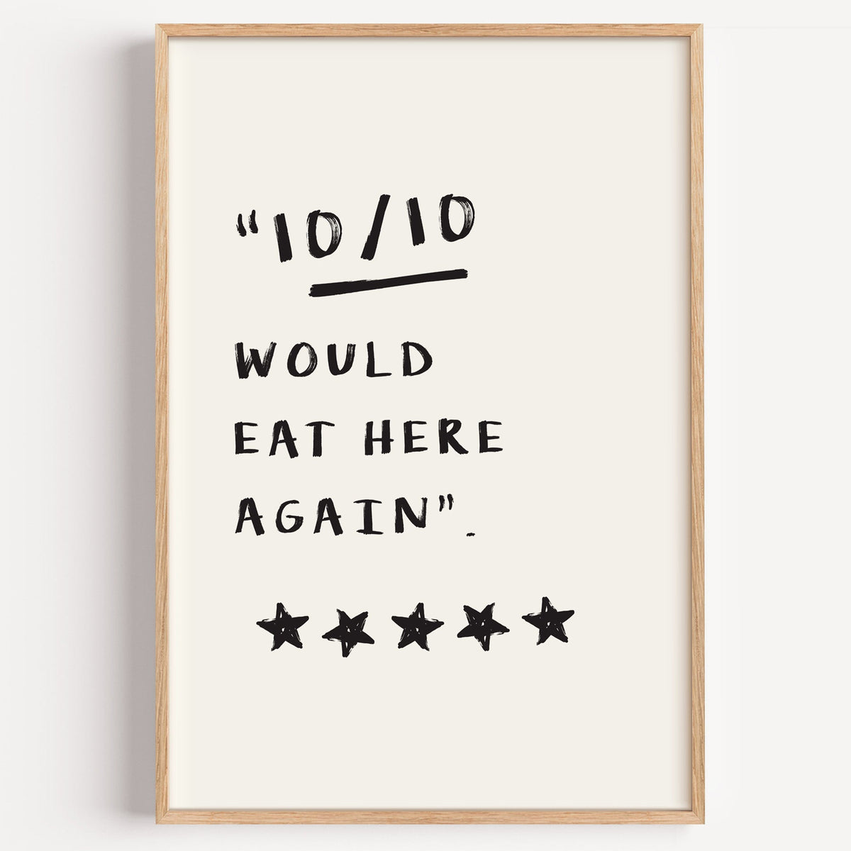 Would eat here again print in a light oak frame on a plain white wall