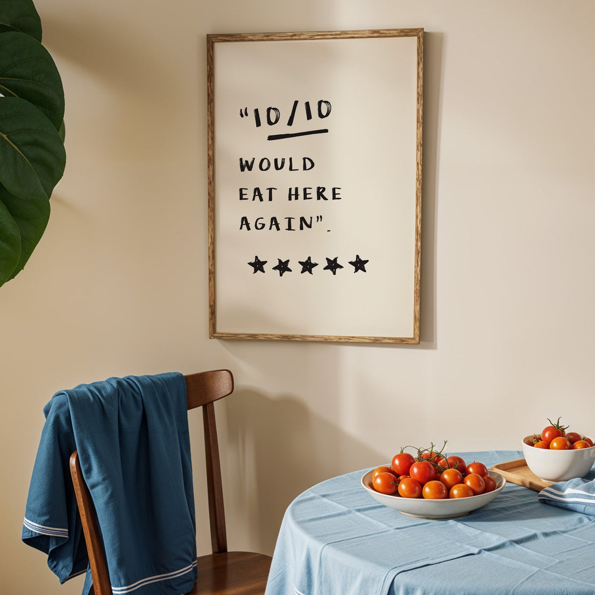Would eat here again print in an oak frame above a blue linen table with tomatoes