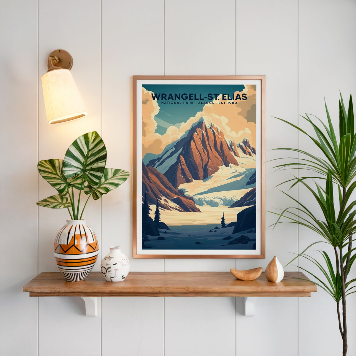 Wrangell–St. Elias National Park print in a copper frame above an oak shelf with a brass sconce