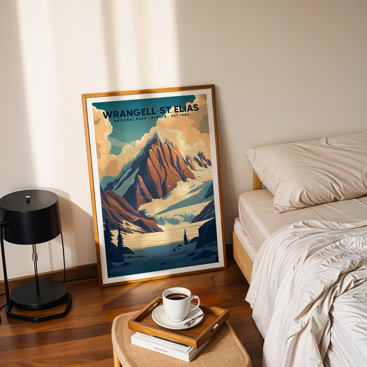 Wrangell–St. Elias National Park print in an oak frame leaning on a bedroom floor beside a coffee tray