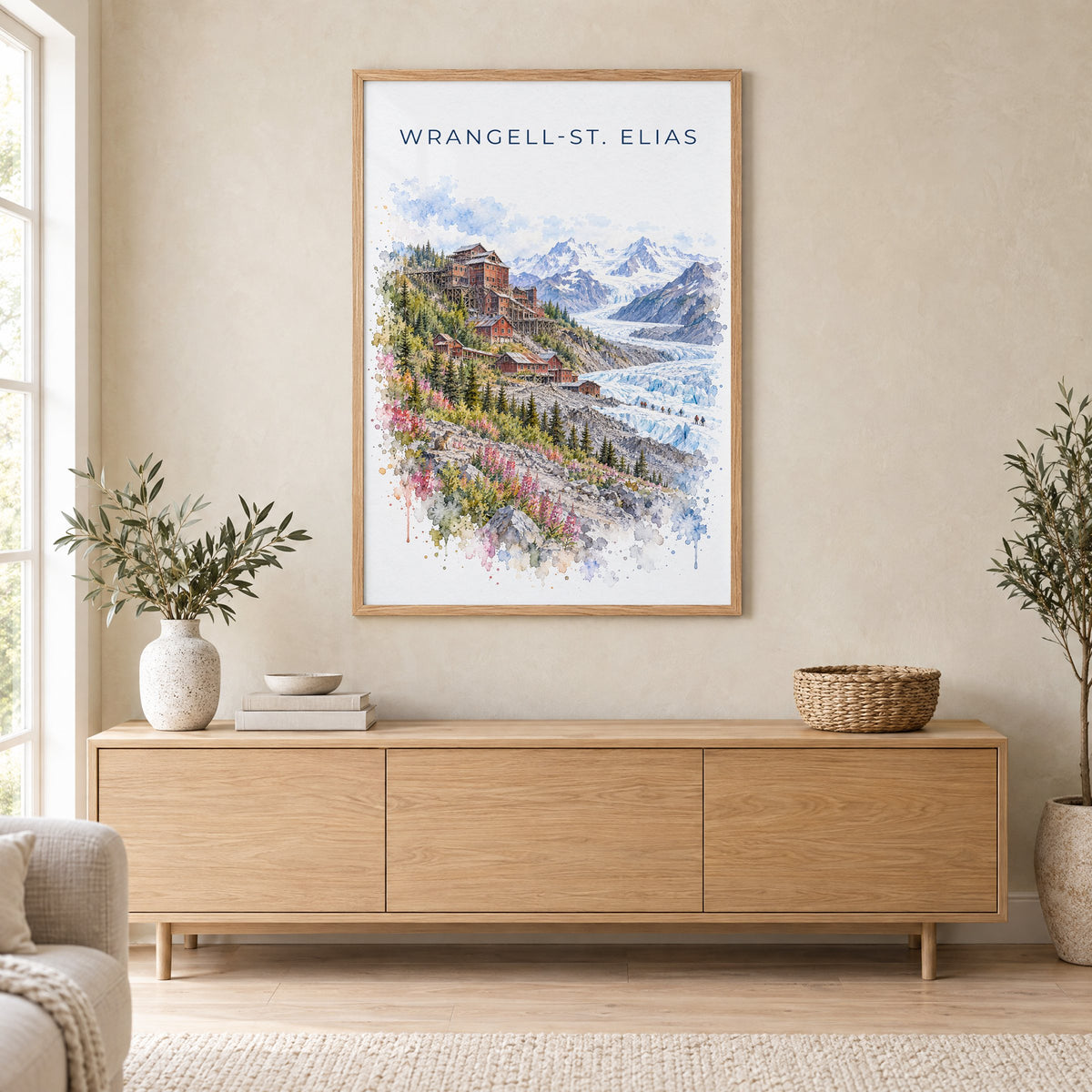 Wrangell-St. Elias National Park watercolor print in an oak frame above a light wood sideboard in a Scandinavian living room