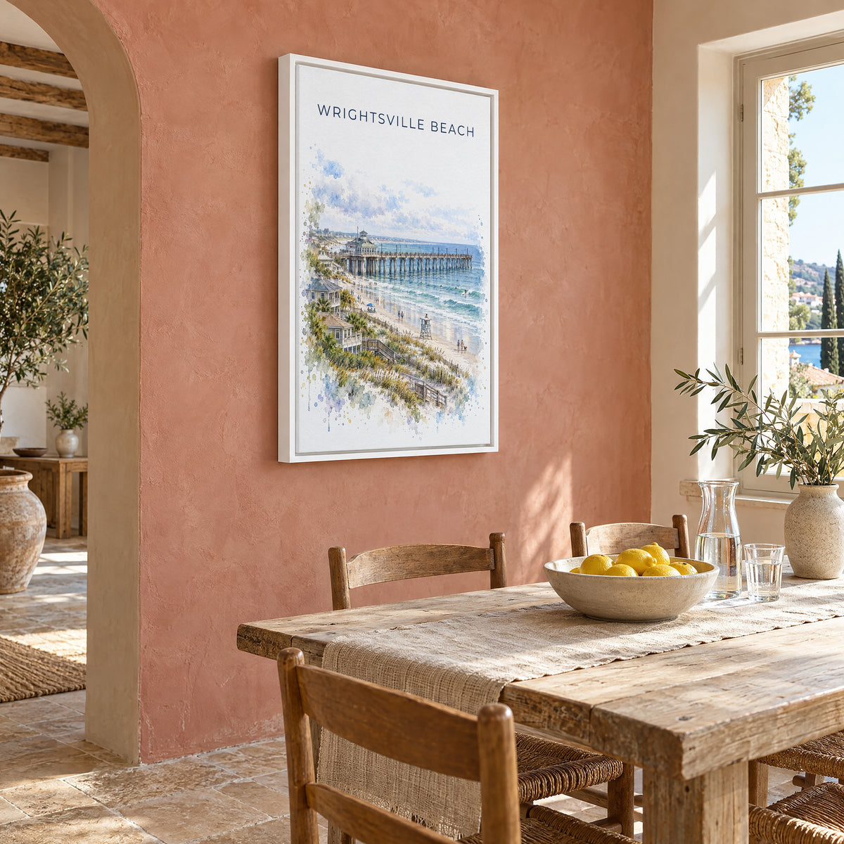 Wrightsville Beach watercolor print as a white floater canvas on a terracotta wall above a rustic dining table
