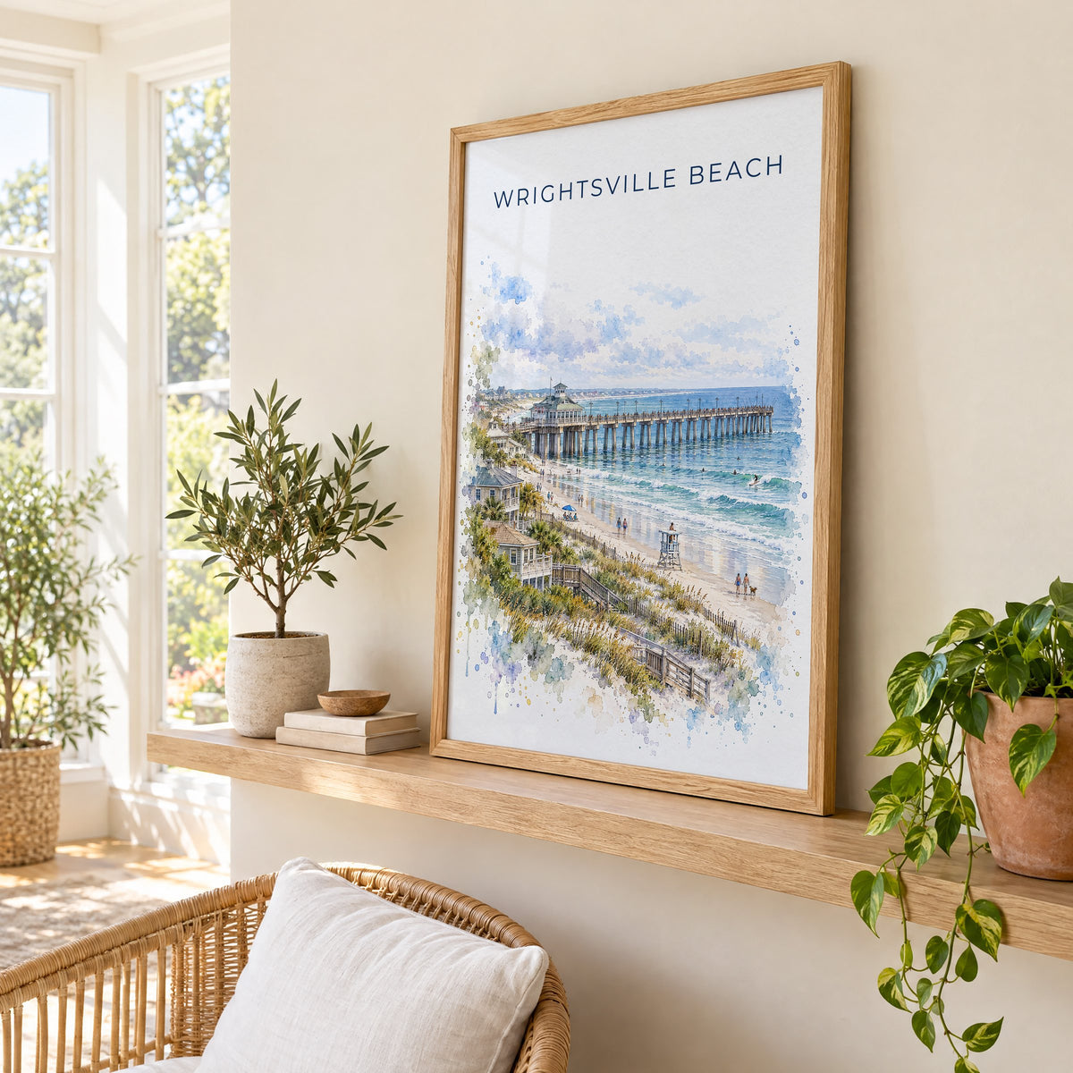 Wrightsville Beach watercolor print in an oak frame on a picture ledge in a sunlit sunroom