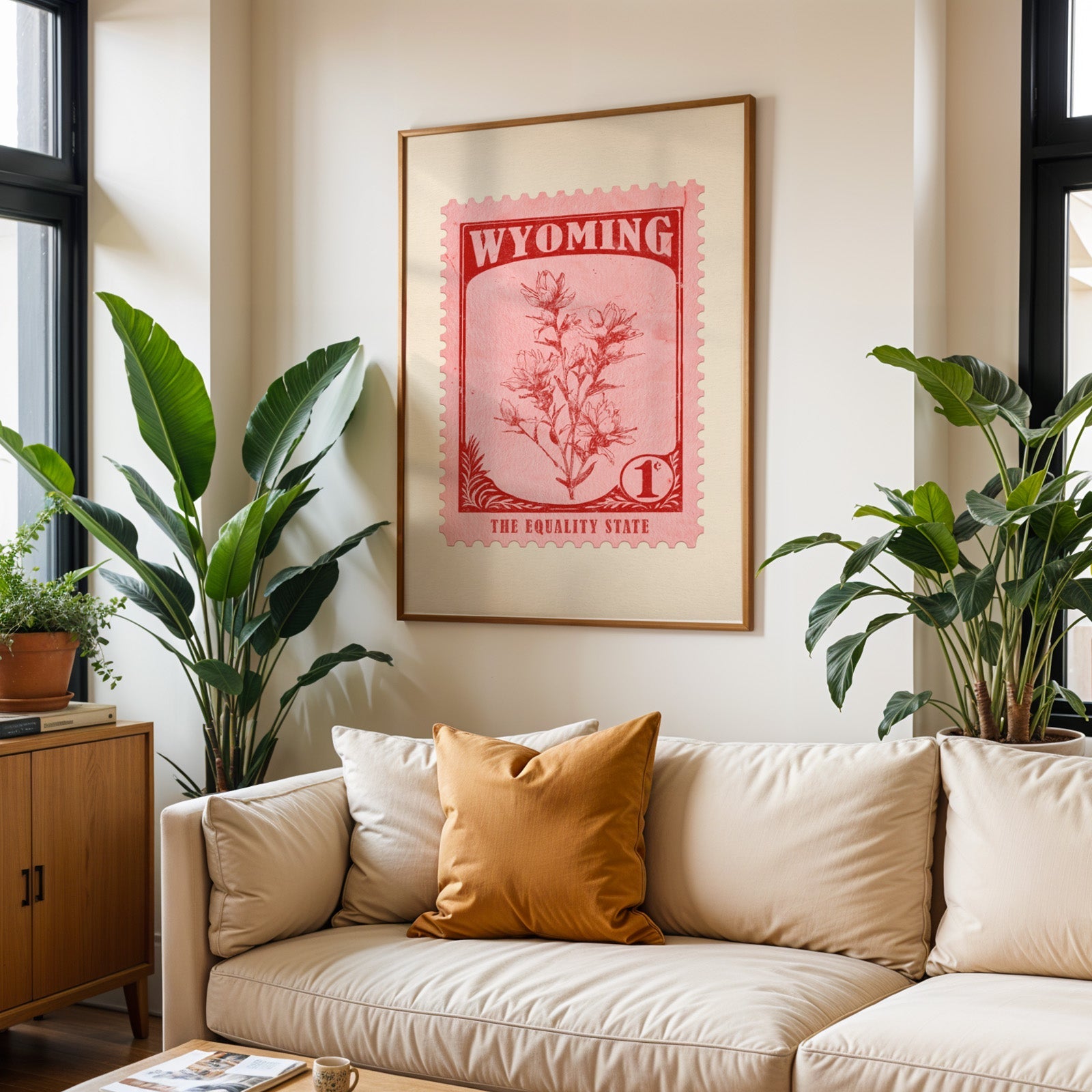 Wyoming state flower print framed above a cream sofa with an ochre cushion and large plants either side