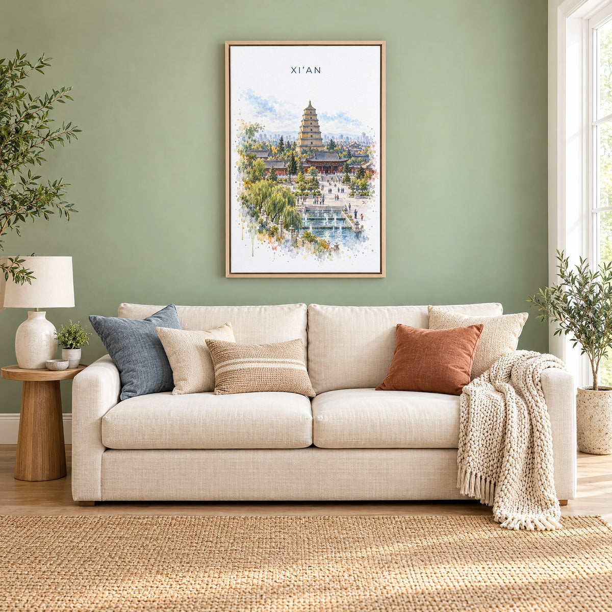 Xi'an watercolor print as a natural floater canvas above a cream linen sofa on a sage green wall