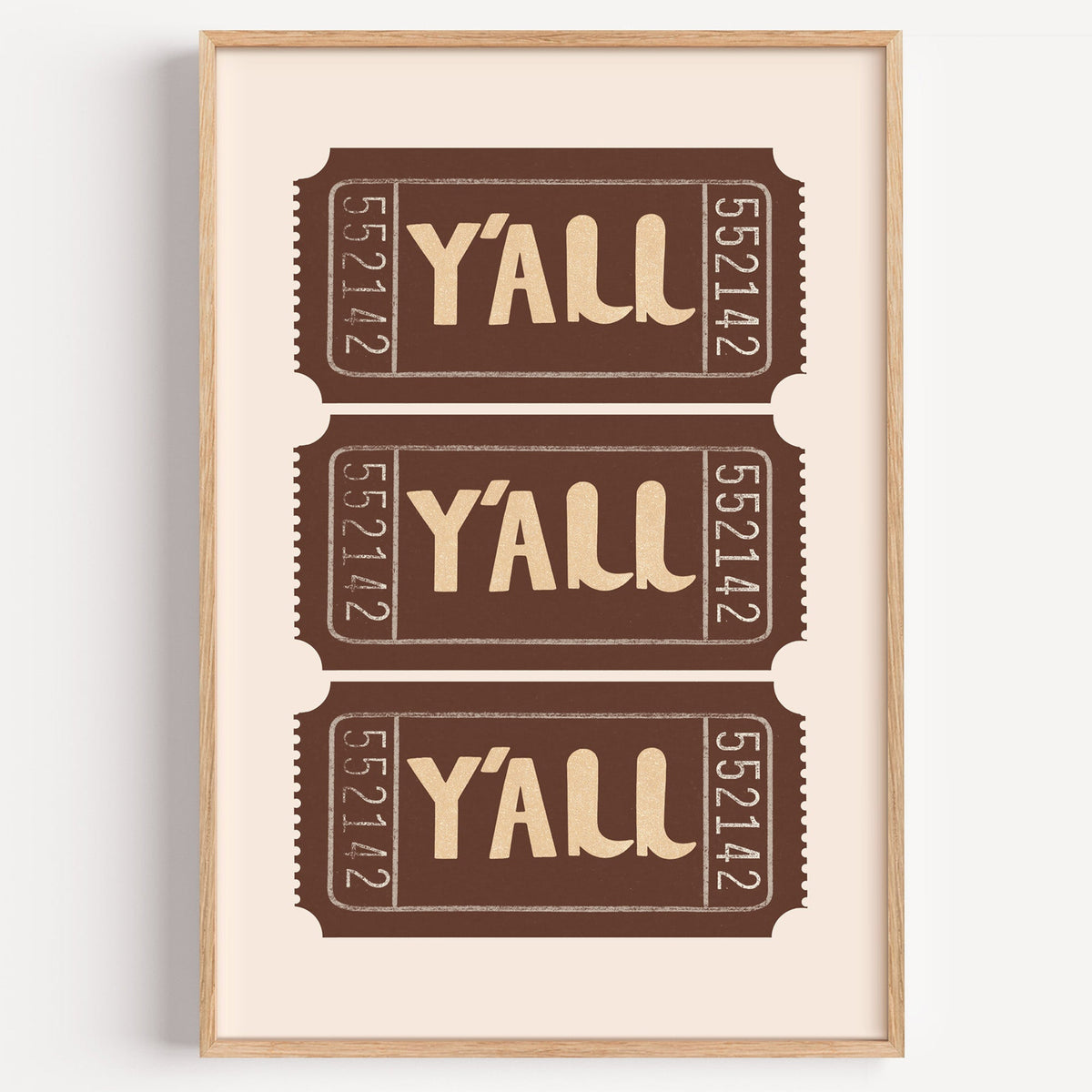 Yall ticket trio print in a light oak frame on a plain white wall