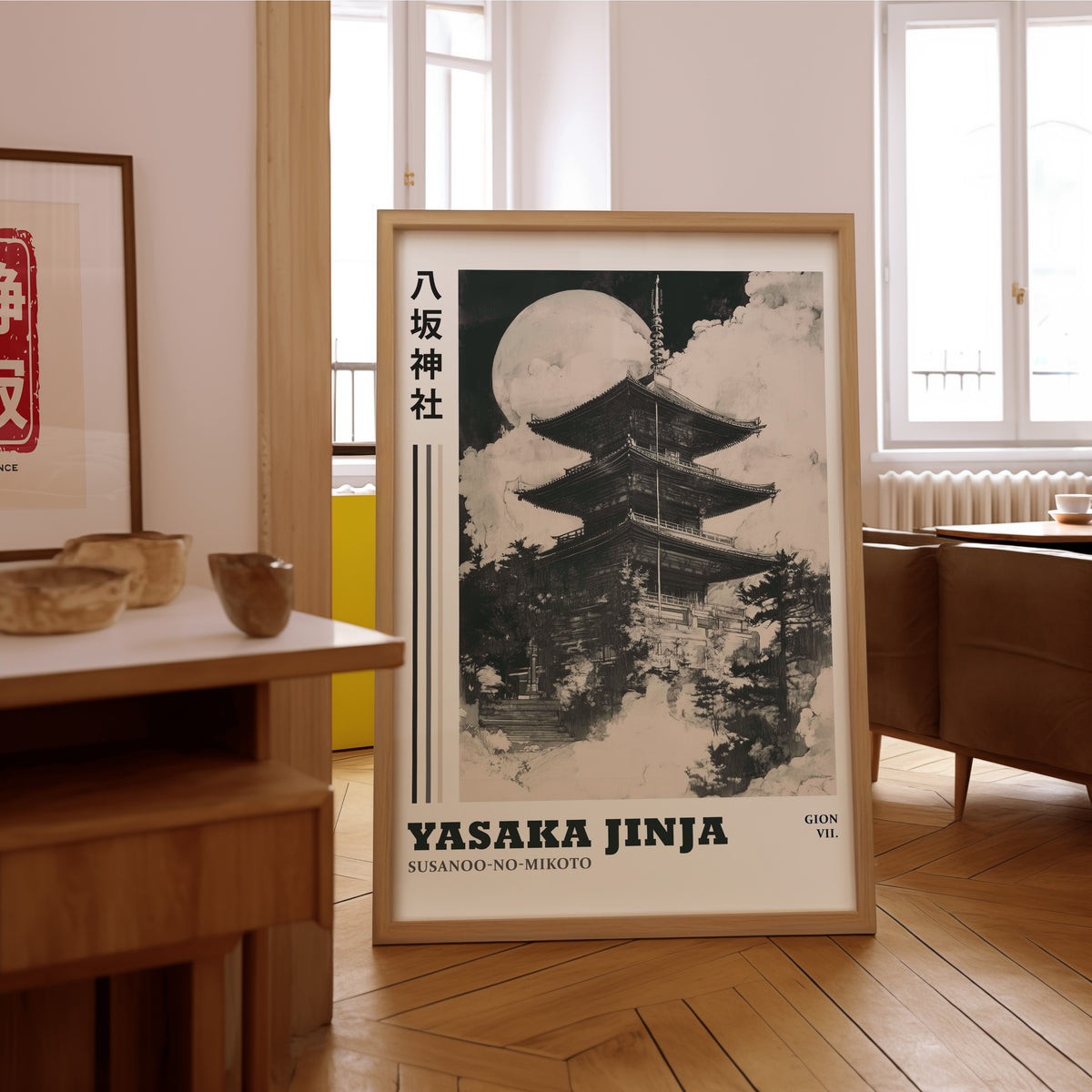 Sumi-e Yasaka pagoda and full moon print in an oak frame on the parquet floor of a sunlit living room