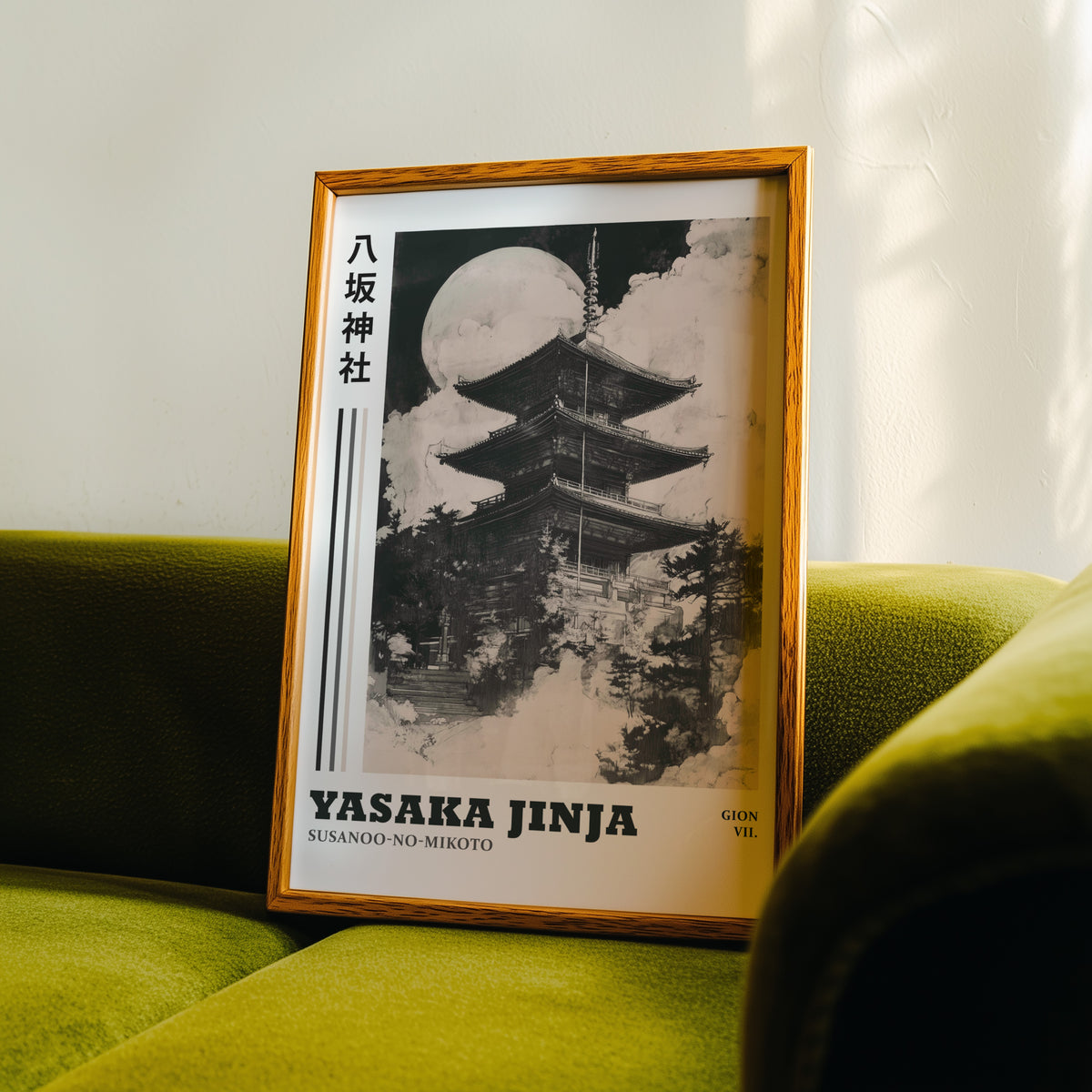 Sumi-e Yasaka pagoda and full moon print in an oak frame propped on a green velvet sofa