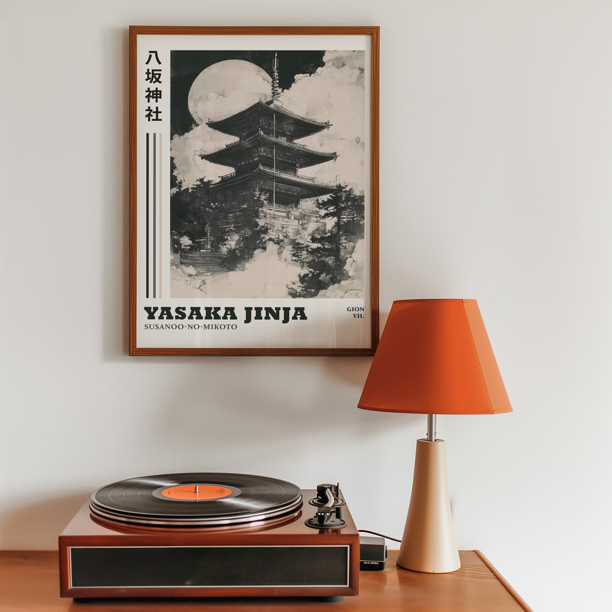 Sumi-e Yasaka pagoda and full moon print in a walnut frame above a sideboard with a record player