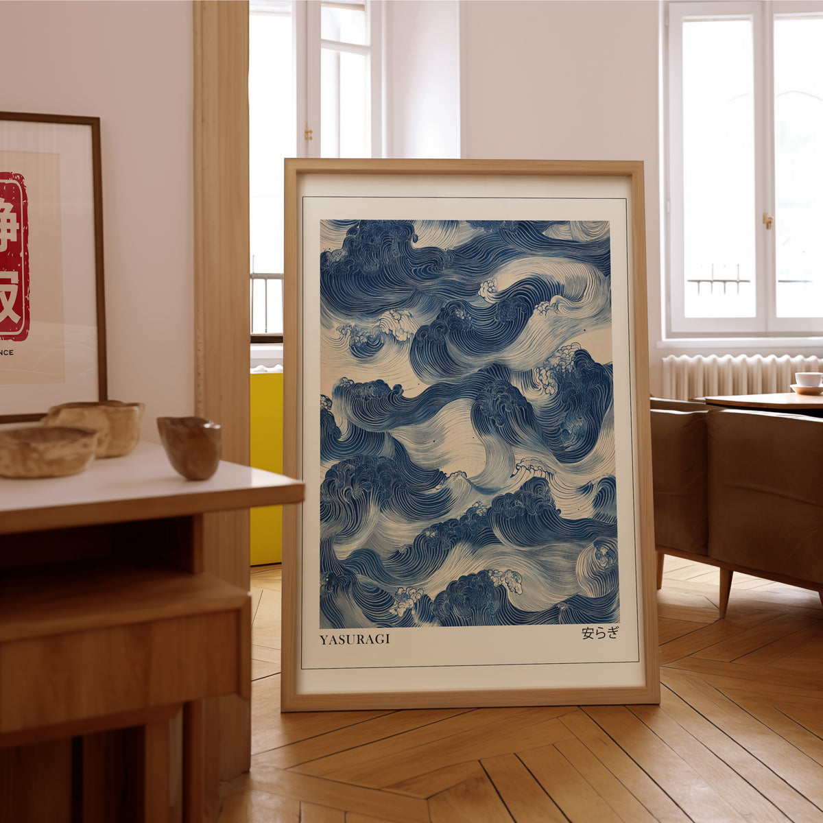 Indigo woodblock Yasuragi waves print in an oak frame on the parquet floor of a sunlit living room