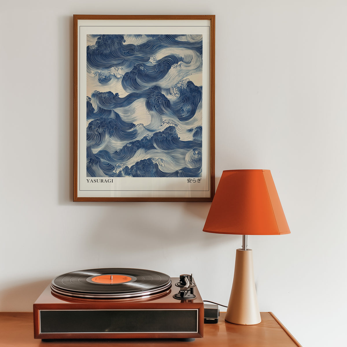 Indigo woodblock Yasuragi waves print in a walnut frame above a sideboard with a record player