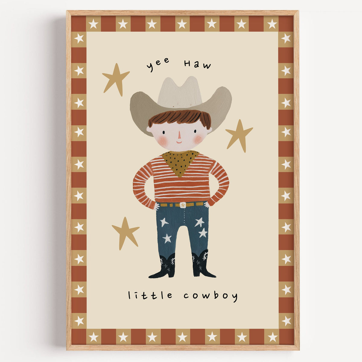 Yee haw cowboy star border nursery print in a light oak frame on a plain white wall