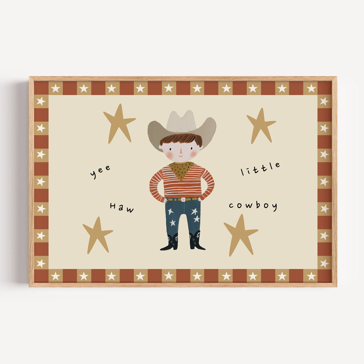 Landscape yee haw cowboy star border nursery print in a light oak frame on a plain white wall
