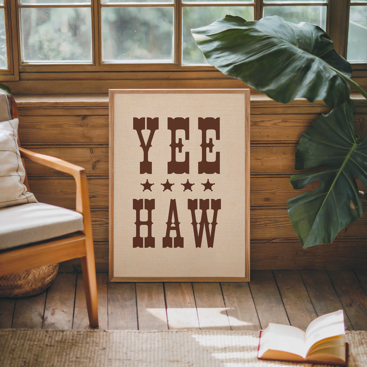 Yee Haw print in an oak frame against a wood panel cabin wall