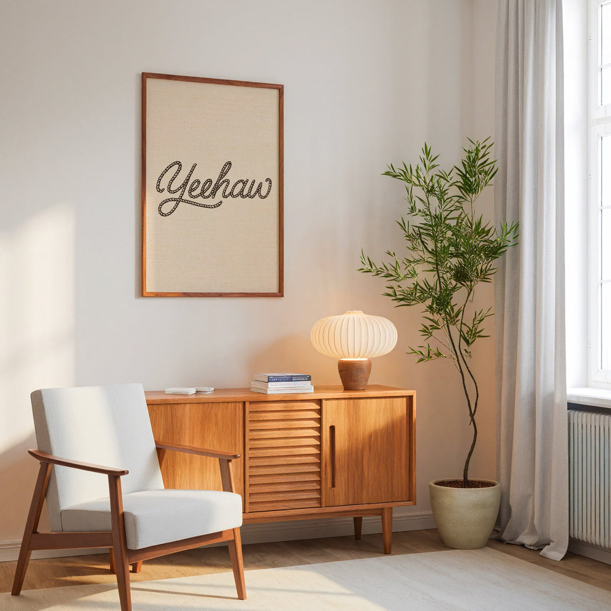 Yeehaw rope script print in an oak frame above a mid-century sideboard