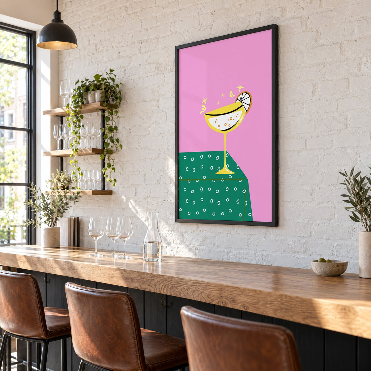 Yellow coupe cocktail print in a black frame on a white brick wall above a wine bar counter