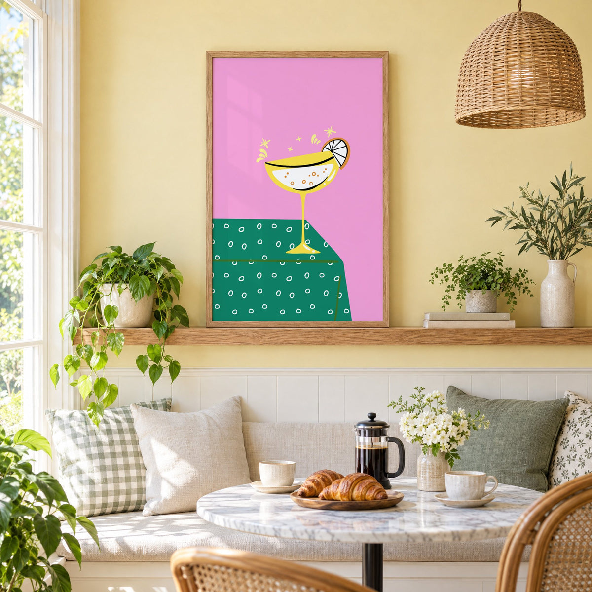 Yellow coupe cocktail print in an oak frame on a picture ledge above a sunny breakfast nook
