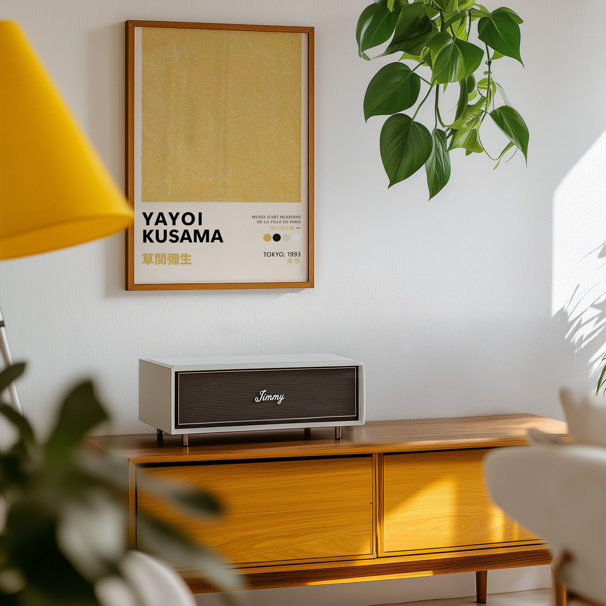 Yayoi Kusama inspired yellow dotted texture print above a sideboard with a plant