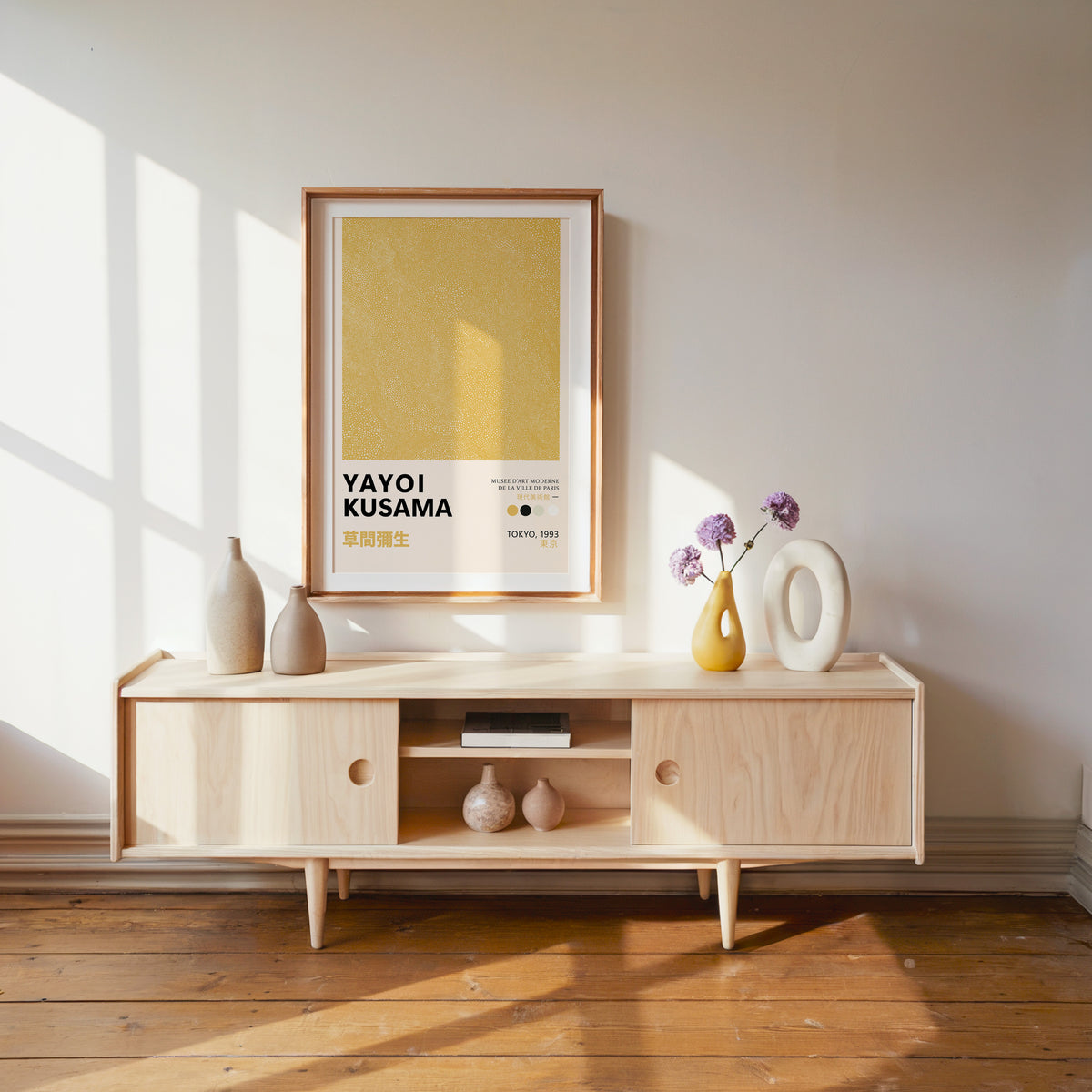 Yayoi Kusama inspired yellow dotted texture print above a pale wood console