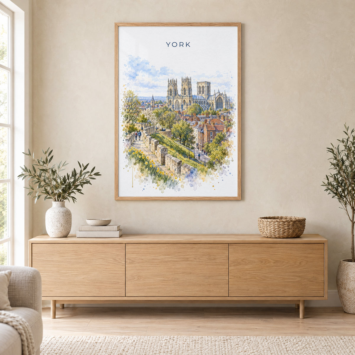 York, England watercolor print in an oak frame above a light wood sideboard in a Scandinavian living room