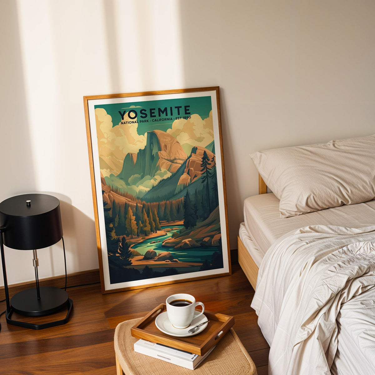 Yosemite National Park print in an oak frame leaning on a bedroom floor beside the bed and a coffee tray