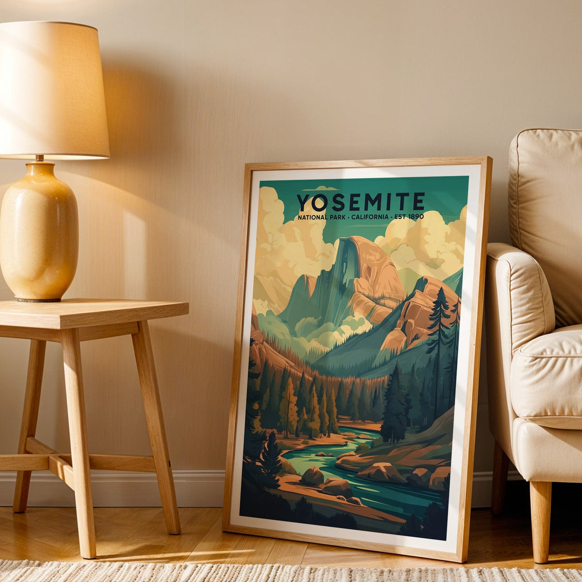 Yosemite print in an oak frame beside a cream armchair and an amber lamp in warm afternoon light