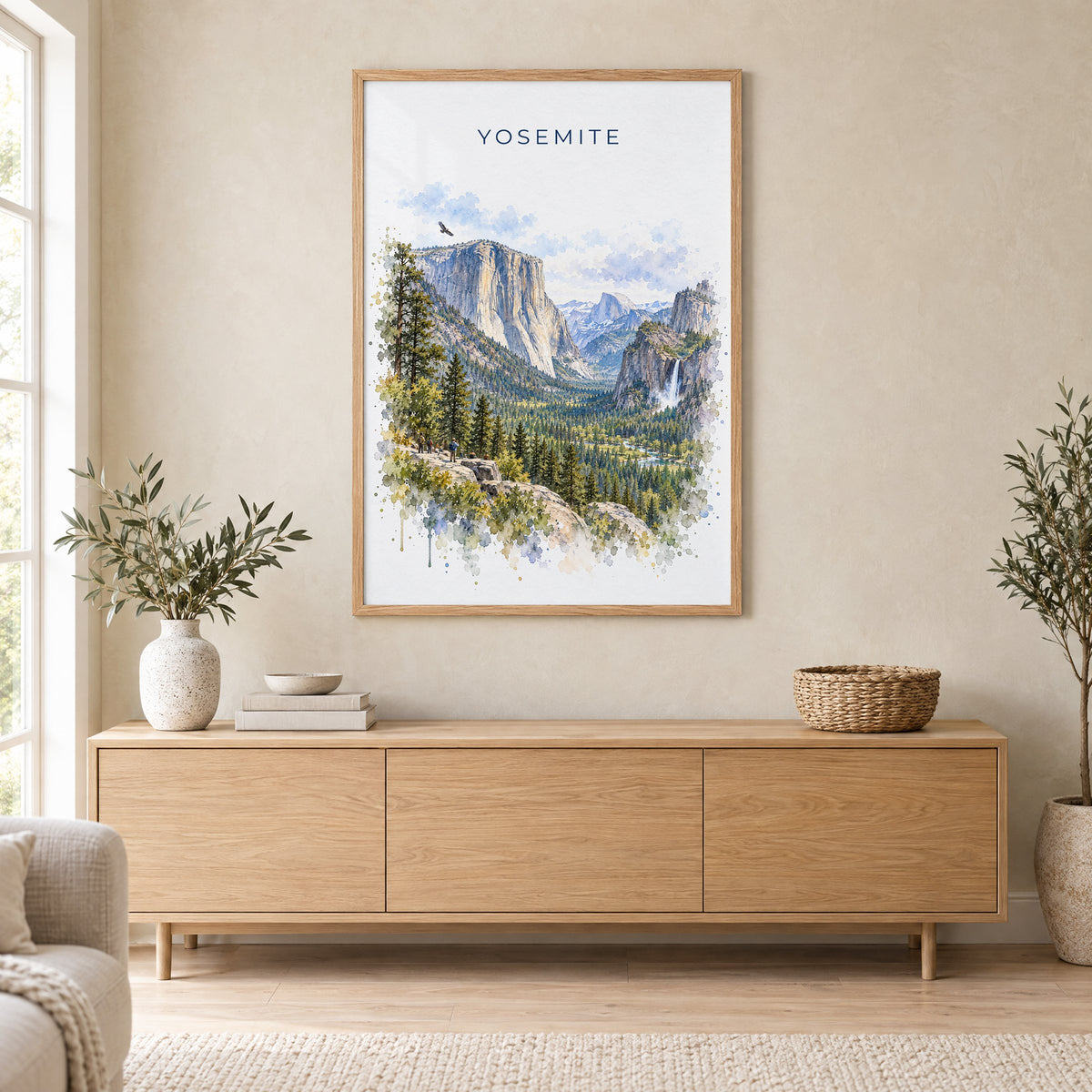 Yosemite National Park watercolor print in an oak frame above a light wood sideboard in a Scandinavian living room