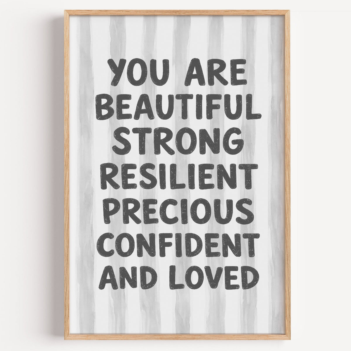 You are beautiful affirmation quote print in a light oak frame on a plain white wall