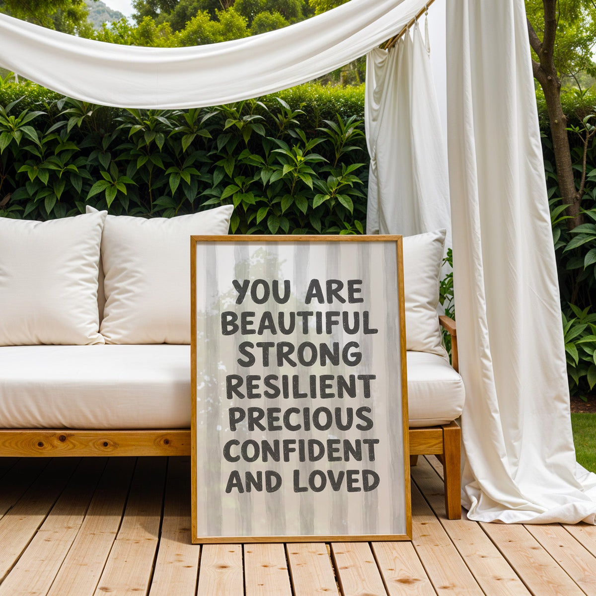 You are beautiful affirmation quote print in an oak frame on an outdoor daybed under white drapes