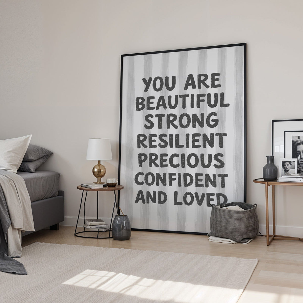 You are beautiful affirmation quote print in a black frame leaning in a bedroom beside a gold lamp
