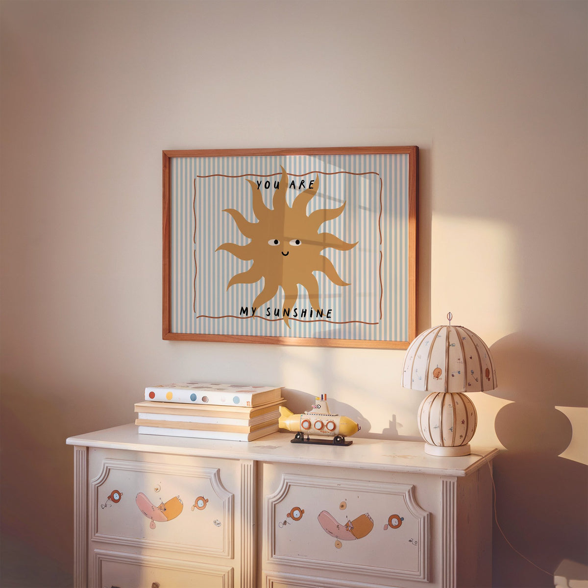 Landscape you are my sunshine sun nursery print in a cherry wood frame above a painted dresser and lamp