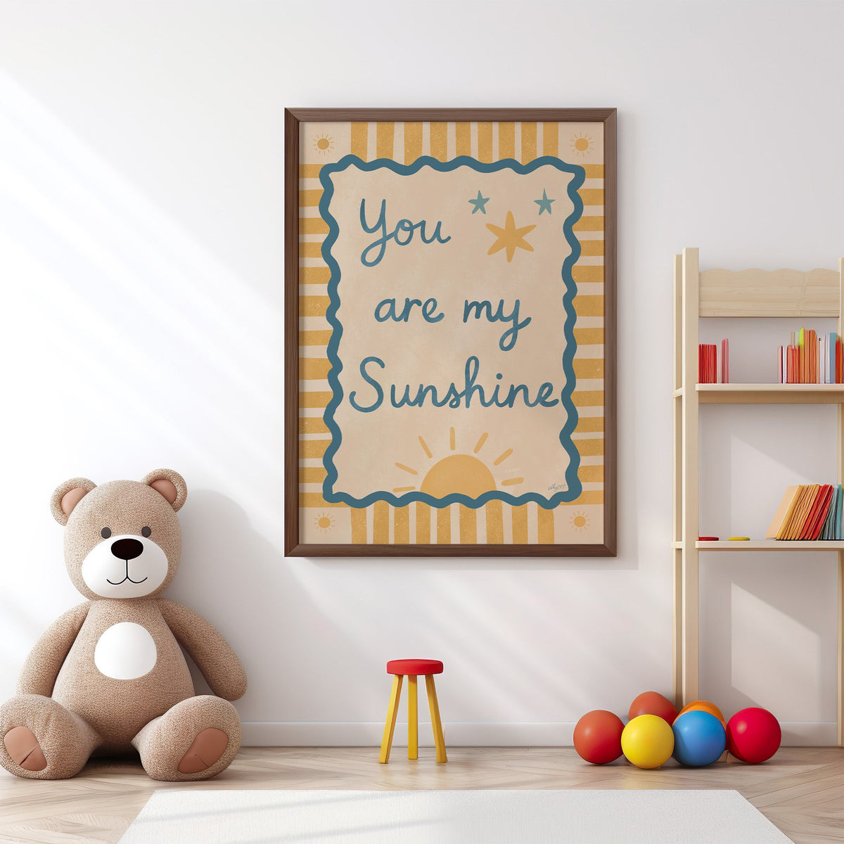 You are my sunshine wavy frame nursery print in a walnut frame above a big teddy bear by a bookshelf
