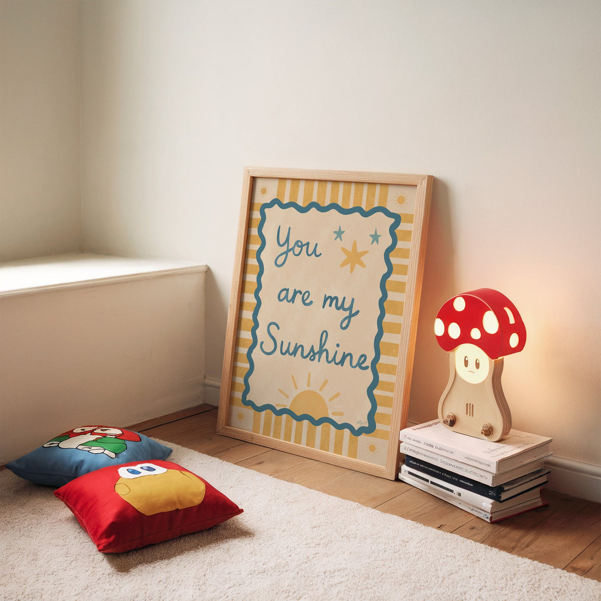 You are my sunshine wavy frame nursery print in an oak frame leaning on a rug beside a mushroom lamp and floor cushions