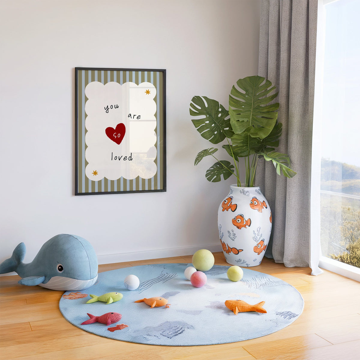 You are so loved heart nursery print in a black frame in a playroom with an ocean rug and whale plush