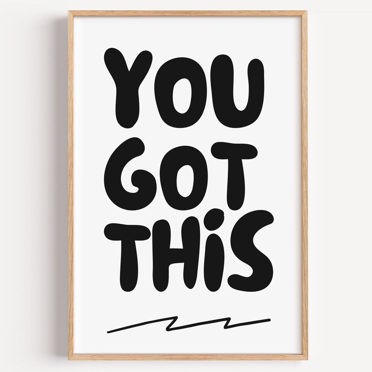 You got this bubble letter quote print in a light oak frame on a plain white wall