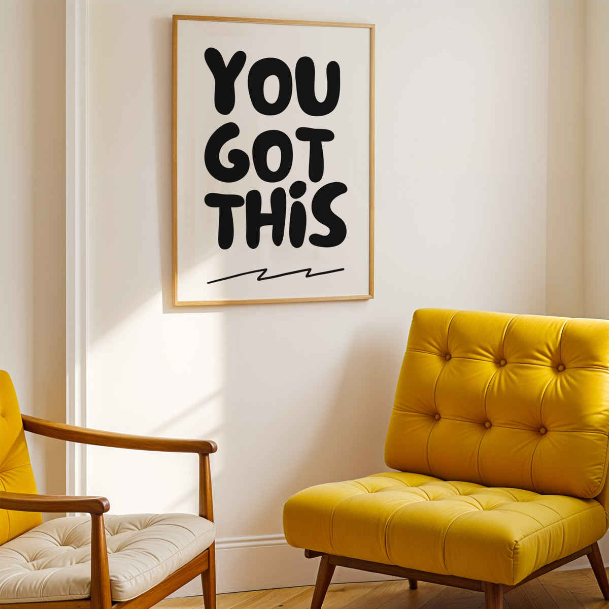 You got this bubble letter quote print shown in a gold frame above a mustard yellow tufted armchair