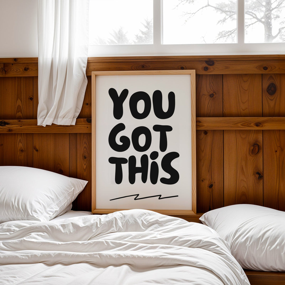 You got this bubble letter quote print in a pine frame leaning on a wood headboard over white bedding