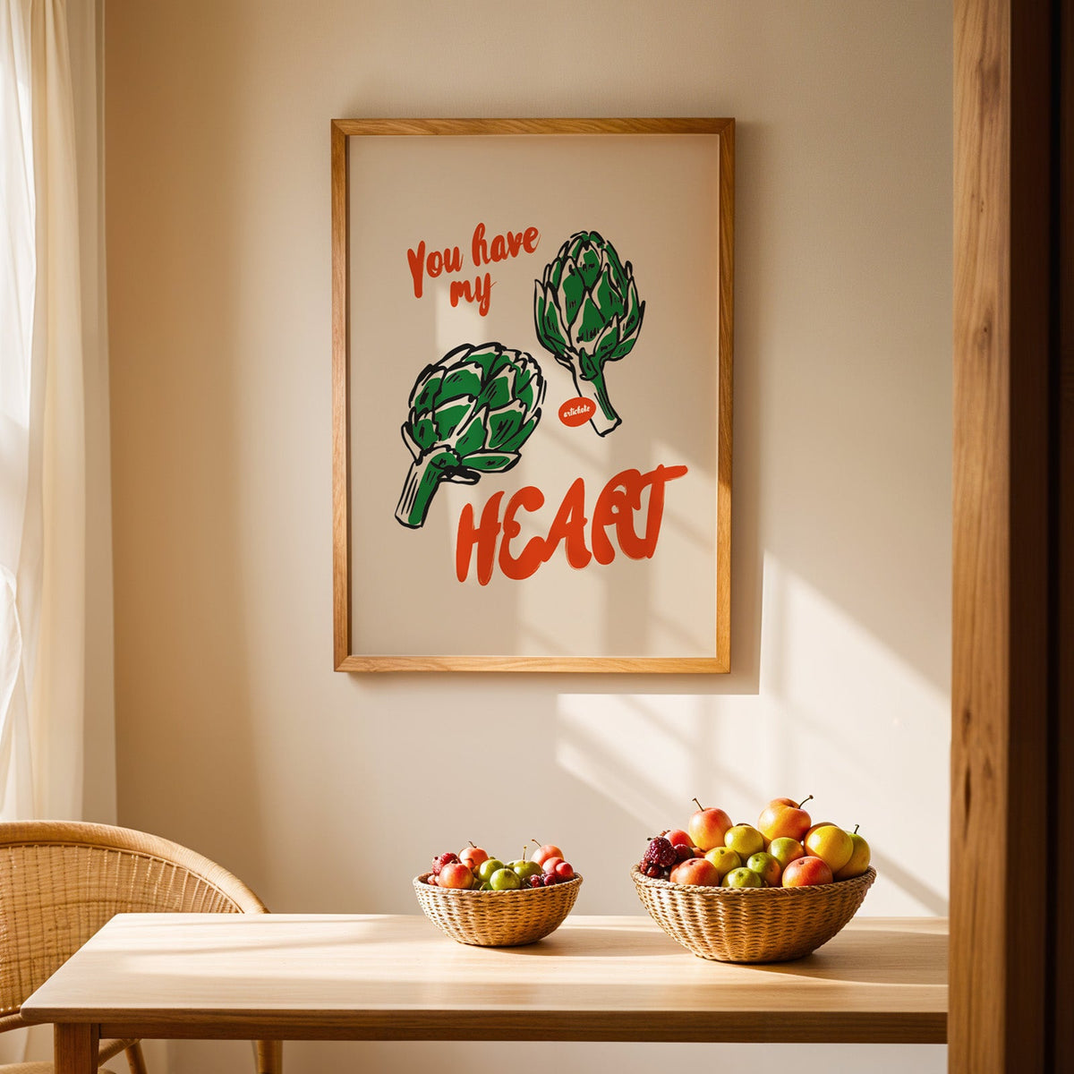 Artichoke print in an oak frame hanging above a dining table with rattan chairs