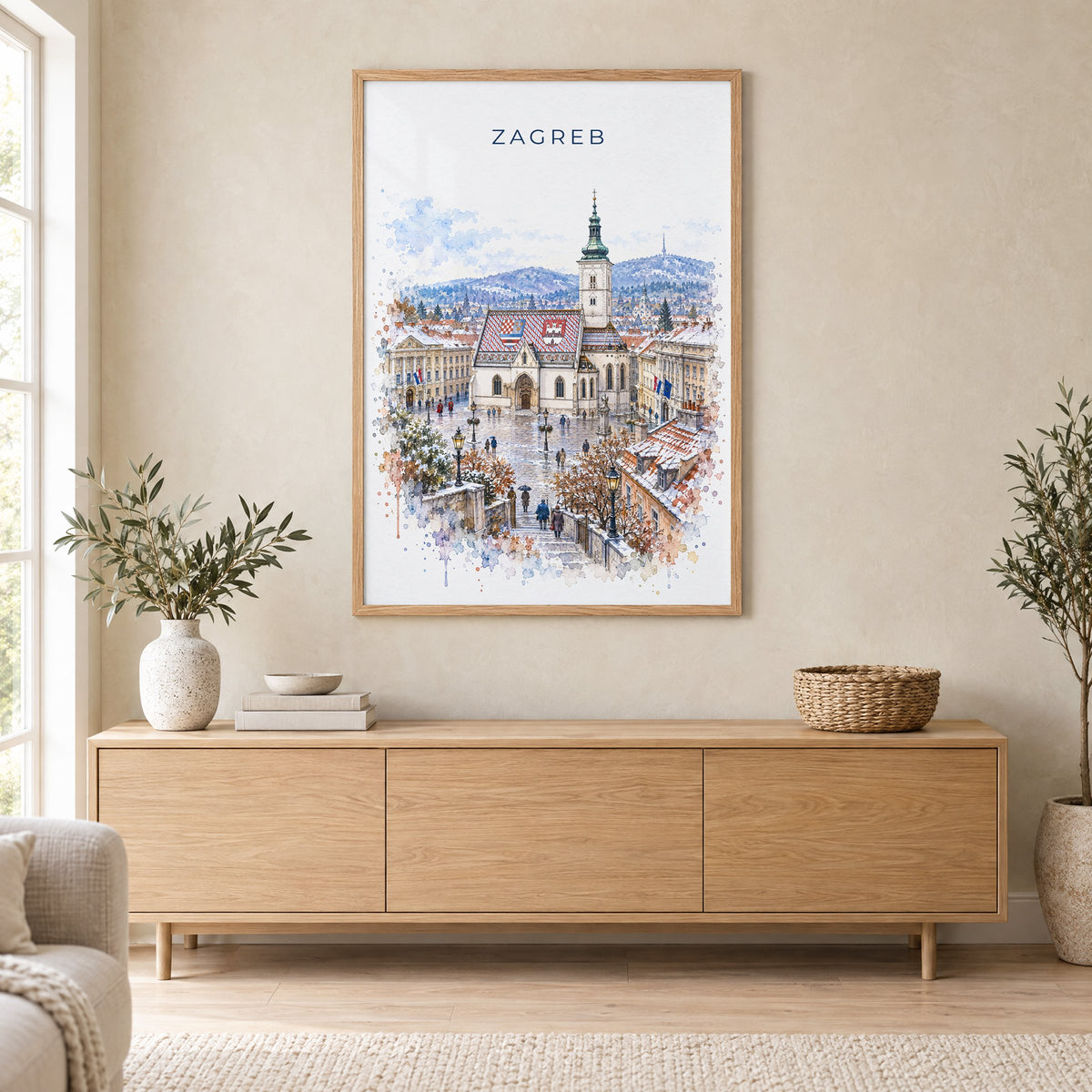 Zagreb watercolor print in an oak frame above a light wood sideboard in a Scandinavian living room