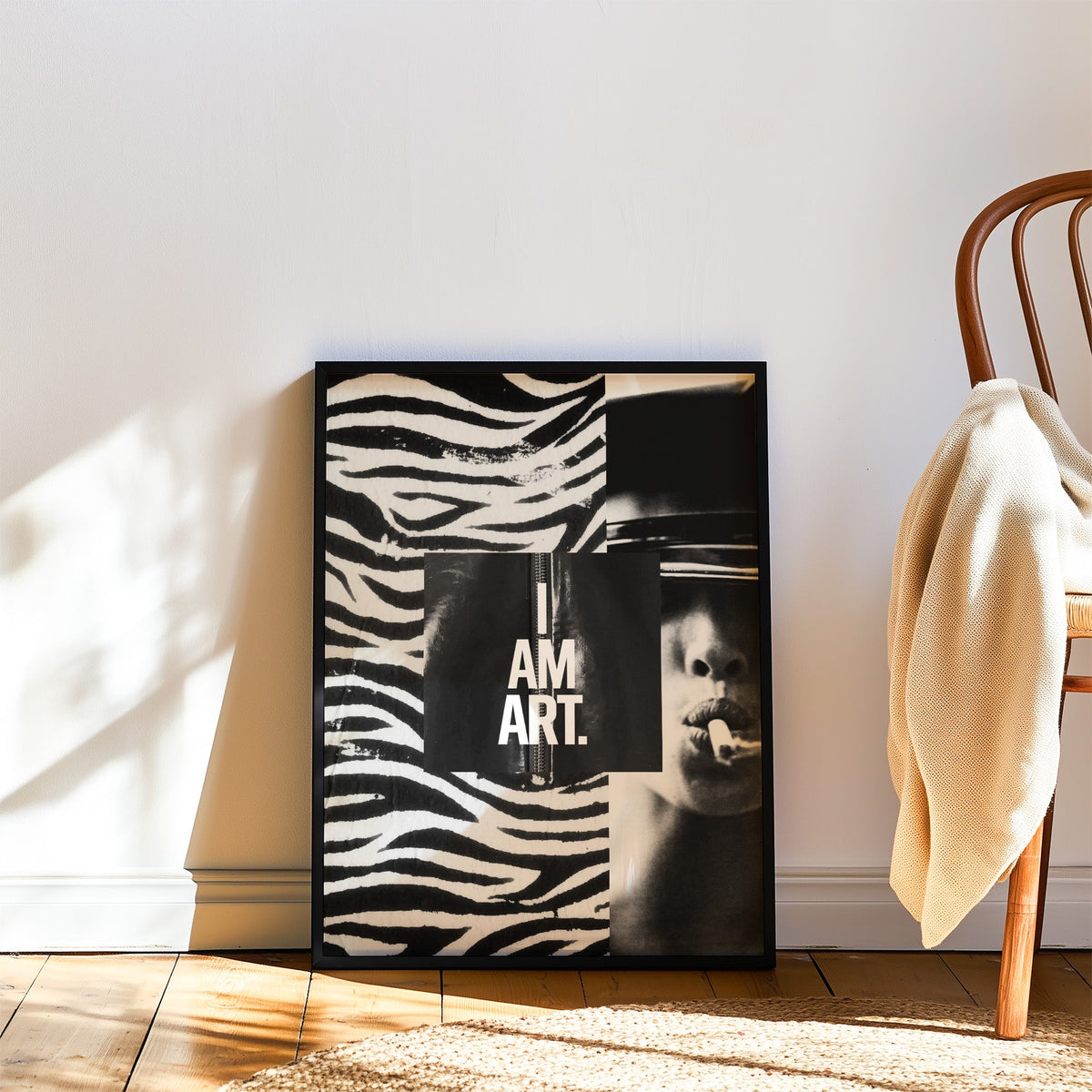 Zebra stripe collage with I am art panel print in a black frame leaning on a wood floor beside a bentwood chair