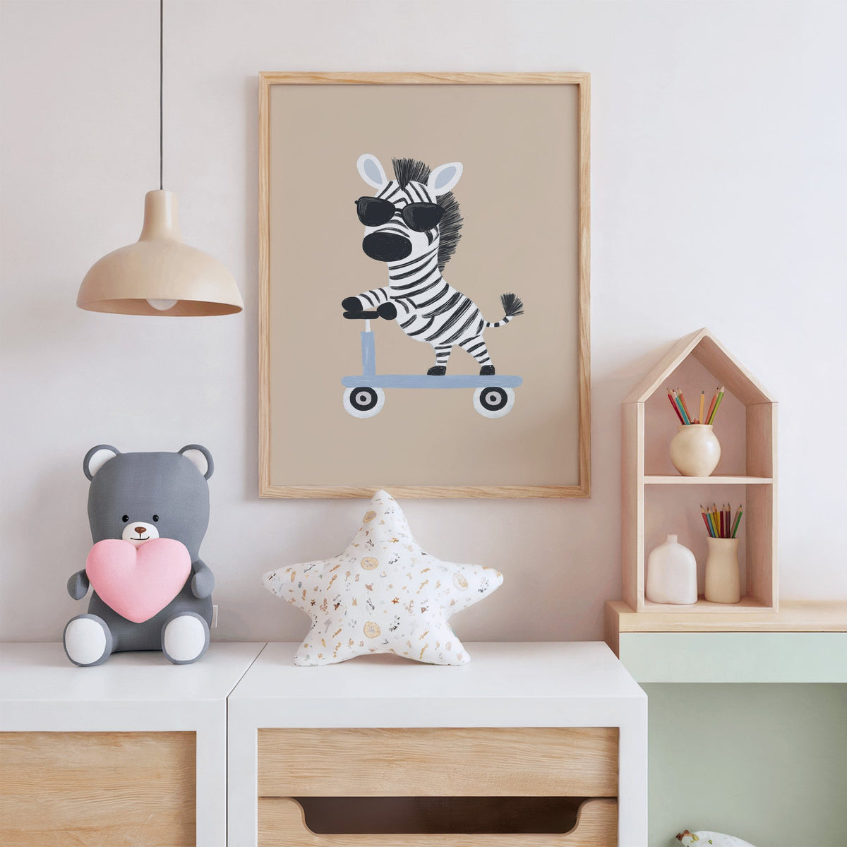 Zebra in sunglasses on scooter nursery print in an oak frame above a white dresser with a star pillow and house shelf