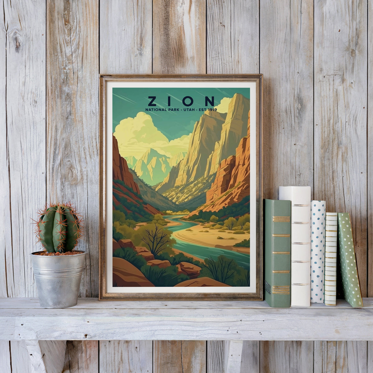 Zion poster in an antique gold frame against whitewashed farmhouse planks beside books and a cactus