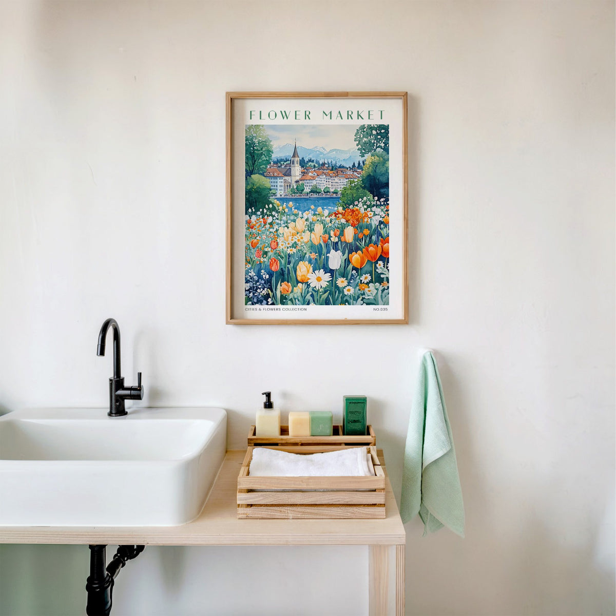 Zurich flower market print in an oak frame above a white bathroom sink with folded towels